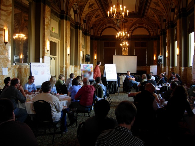 A picture of a room with chandeliers and high, painted ceiling.